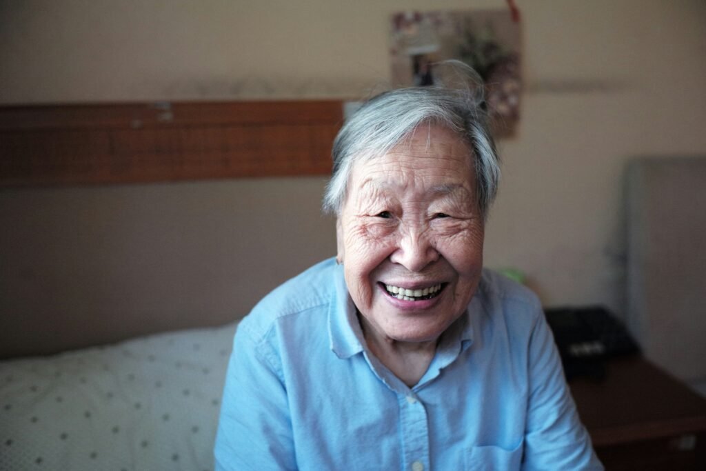 This Asian senior in a blue collared top trusts the Medicare agent near me to take care of her health insurance needs.